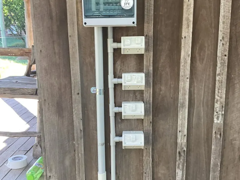 Weatherproof outdoor power points and an enclosure mounted on a timber post